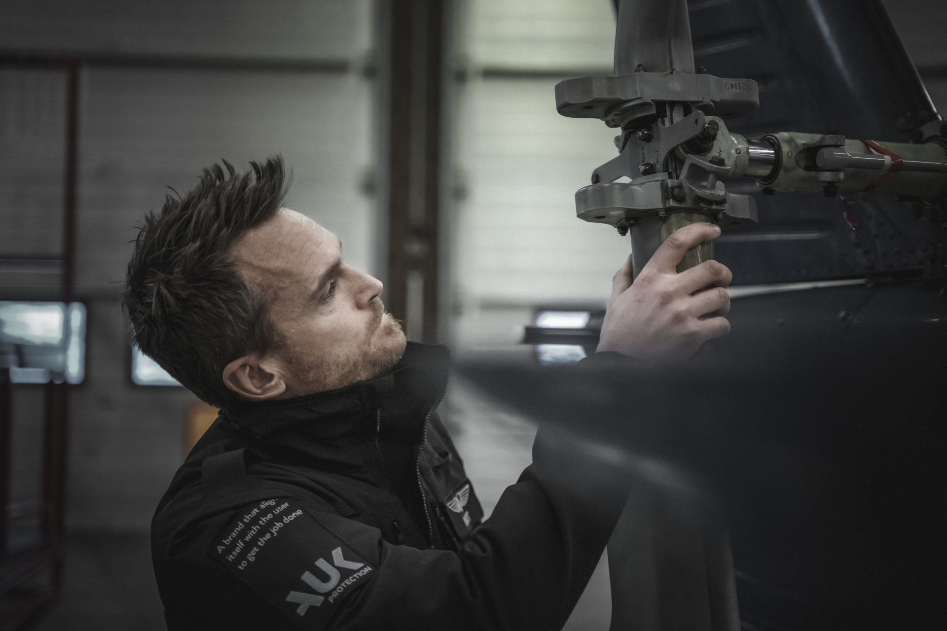 man working and wearing a black jacket from auk protection